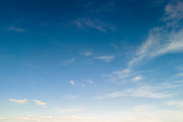 Clear blue sky with soft clouds, creating a serene and peaceful atmosphere. Perfect for nature or background use.