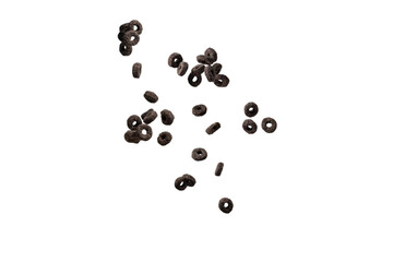 Chocolate rings cereal spill out into a bowl. Breakfast.