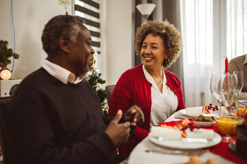 Grandparents having fun at their Thanksgiving, Christmas dinner.