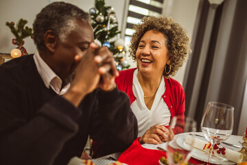 Grandparents having fun at their Thanksgiving, Christmas dinner.
