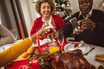 African American family drinking wine at the Thanksgiving, Christmas dinner.
