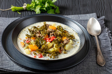 ground beef veggies kale soup in black bowl