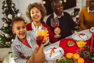 African American man giving speach at the family Christmas dinner.