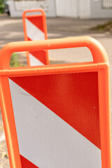 Orange warning banner on the road to warn of roadworks and traffic obstructions that cause traffic jams.