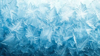 Frozen pattern on winter glass. Blue ice frost background, texture blue wallpaper. Crystals of snow on window surface. Screen overlay abstract design