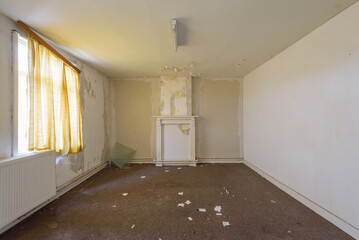 Abandoned room with soft tones and bright light and paper clutter on the floor