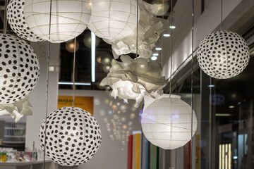 White polka dot lanterns gracefully hang from the ceiling