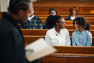 Mother and daughter sharing a moment during church service