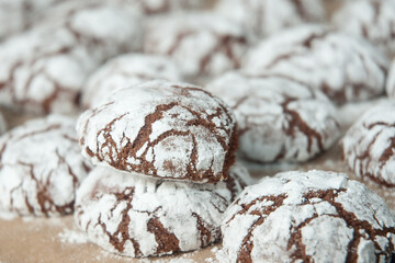 Chocolate cookies with white powder on baking sheet, sweet dessert.