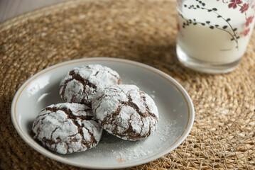 Chocolate cookies and a cup of milk on the table, a sweet dessert.