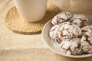 Chocolate cookies and a cup of milk on the table, a sweet dessert.