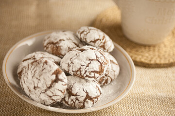 Chocolate cookies and a cup of milk on the table, a sweet dessert.