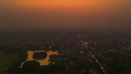 Aerial view of a tranquil town basking in the warm glow of a sunset haze