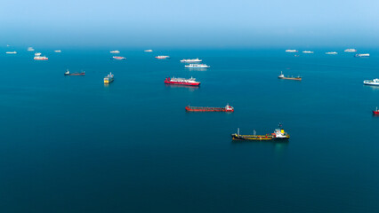 Serene seascape with a fleet of cargo ships dotting the tranquil blue ocean, capturing the essence of maritime logistics and global trade