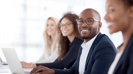 Smiling professionals collaborating in a bright office environment, showcasing teamwork and productivity.