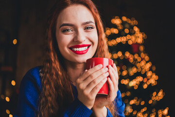 Photo of attractive young woman drink coffee mug dressed blue christmas outfit cozy day light home...