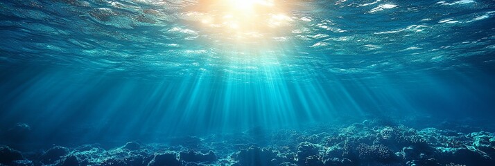 A beautiful blue ocean with sunlight shining through the water. The sunlight creates a serene and peaceful atmosphere, making the scene feel calm and relaxing. The water is clear and deep