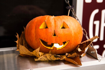 Pumpkin head with autumn foliage, closeup, Halloween concept