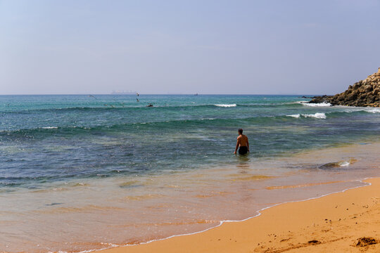 a beautiful view on a man swiming at the beach of Safi in Morocco 