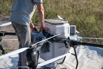 Operator replacing battery of agricultural drone.