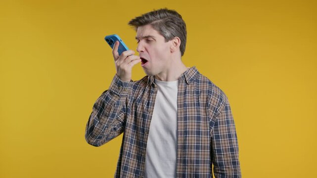 Angry handsome man quarreling, screaming talking on mobile phone. Guy in stress