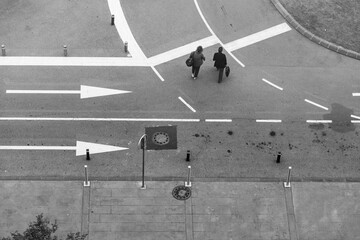 two people crossing the road by an intersection