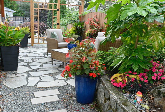Outdoor tropical terraced patio in backyard garden for casual outdoor seating
