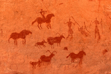 Animals and people - prehistoric petroglyph, rock art at Tadrart Rouge, Tadrart Akkak, Sahara,...