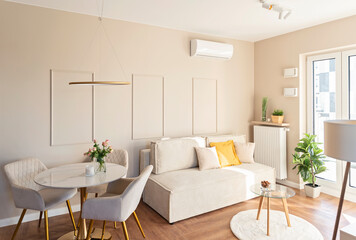 Modern living room with wooden floor, window and sofa in design interior in new apartment. Real estate and luxurious decor.
