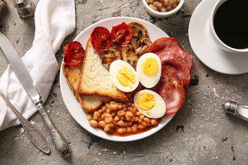 Plate with tasty English breakfast and cup of coffee on grey background