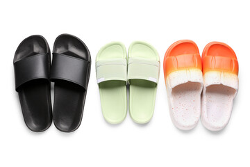Colorful pairs of female flip flops on white background