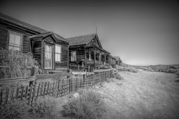 Wooden houses line a dusty street in Bodie Ghost Town, California. This well-preserved slice of the...
