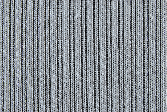 Gray melange ribbed knit fabric pattern close up as background