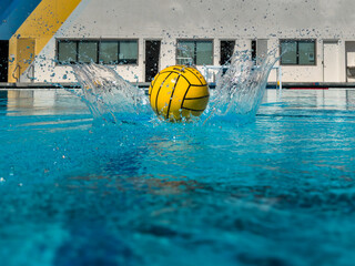 Yellow Water Polo Ball Splashing on Top of Water

