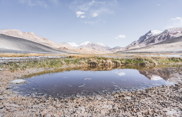 Panoramic landscape of textured Tien Shan mountains in Pamir in Tajikistan, panoramic landscape of a mountain range with snow and glaciers in summer