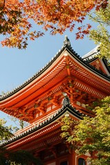 Fototapeta premium Red Japanese temple roof with autumn leaves. Kyoto, Japan
