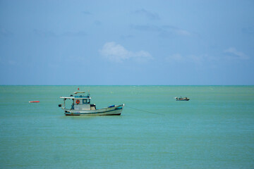 Fishing boats on the ocean. Ponta Negra Beach, Natal, Brazil.