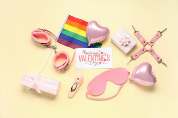 Fototapeta premium Festive postcard with sex toys, gifts and rainbow LGBT flag on yellow background. Valentine's Day celebration