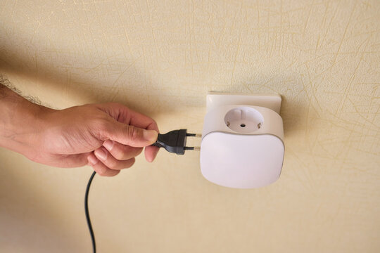 Hand Plugging in an Electrical Device for Essential Power Supply and Utility Connection