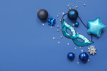 Beautiful carnival mask and Christmas decor on blue background