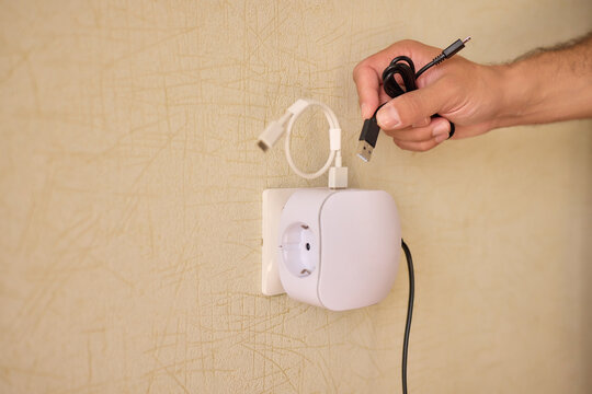 Hand Plugging in an Electrical Device for Essential Power Supply and Utility Connection
