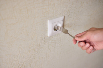 The Use of a Fork on an Electrical Outlet Presents Serious Dangers and Should Be Avoided