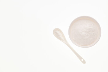 Baking soda - Crystalline solid compound in spoon and bowl.