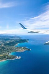 Obraz premium Wing of an airplane flying above the sea. View from airplane window