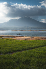 A large volcano behind a lake