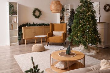 Interior of cozy living room with armchair, table and Christmas trees