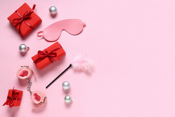Composition with sex toys, gift boxes and Christmas decorations on pink background