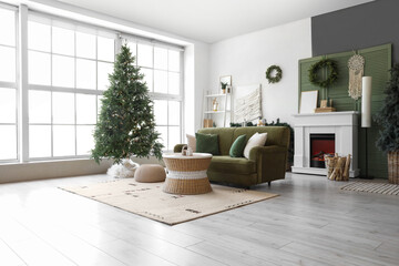 Interior of living room with green sofa, fireplace, Christmas tree and festive decorations