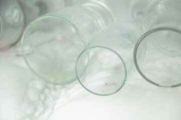 several empty glasses were stacked on top of each other in the refrigerator
