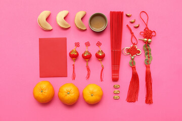 Fortune cookies with mandarins and Chinese symbols on pink background. New Year celebration